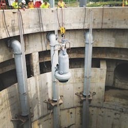 One_of_nine_Flygt_pumps_being_lowered_into_position_in_deep_well_copy