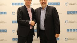 Mark Fisher, president and CEO of the Council of the Great Lakes Region, and Dean Amhaus, president and CEO of The Water Council shake hands after signing partnership agreement.