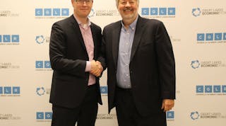 Mark Fisher, president and CEO of the Council of the Great Lakes Region, and Dean Amhaus, president and CEO of The Water Council shake hands after signing partnership agreement.