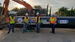 The design built team poses with the force main pipe at the construction site in Fort Lauderdale.
