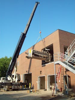 A crane raises a gravity belt thickener into the second floor. A crane raises a gravity belt thickener into the second floor.