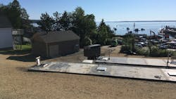 The WRF overlooking the Penobscot Bay includes an anoxic tank (foreground), an aerated reactor (not pictured), a storage tank for treated effluent (mid-photo), and a control building to match the coastal aesthetic. The WRF overlooking the Penobscot Bay includes an anoxic tank (foreground), an aerated reactor (not pictured), a storage tank for treated effluent (mid-photo), and a control building to match the coastal aesthetic.