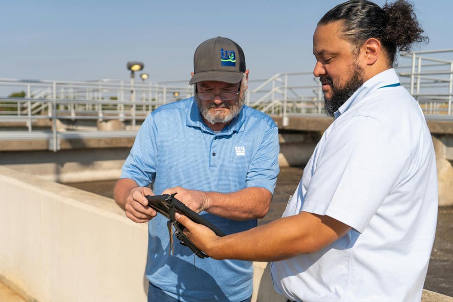 Mike Easley, chief operator at Ten Mile Creek Regional Wastewater System, reviews data with David Naranjo to determine if adjustments are needed.
