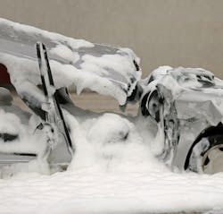 A wrecked car with firefighting foam. A wrecked car with firefighting foam.