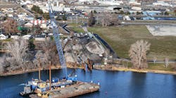 A crane floats on a barge during construction of the Pasco, Washington wastewater treatment plant. A crane floats on a barge during construction of the Pasco, Washington wastewater treatment plant.