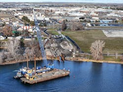 A crane floats on a barge during construction of the Pasco, Washington wastewater treatment plant. A crane floats on a barge during construction of the Pasco, Washington wastewater treatment plant.