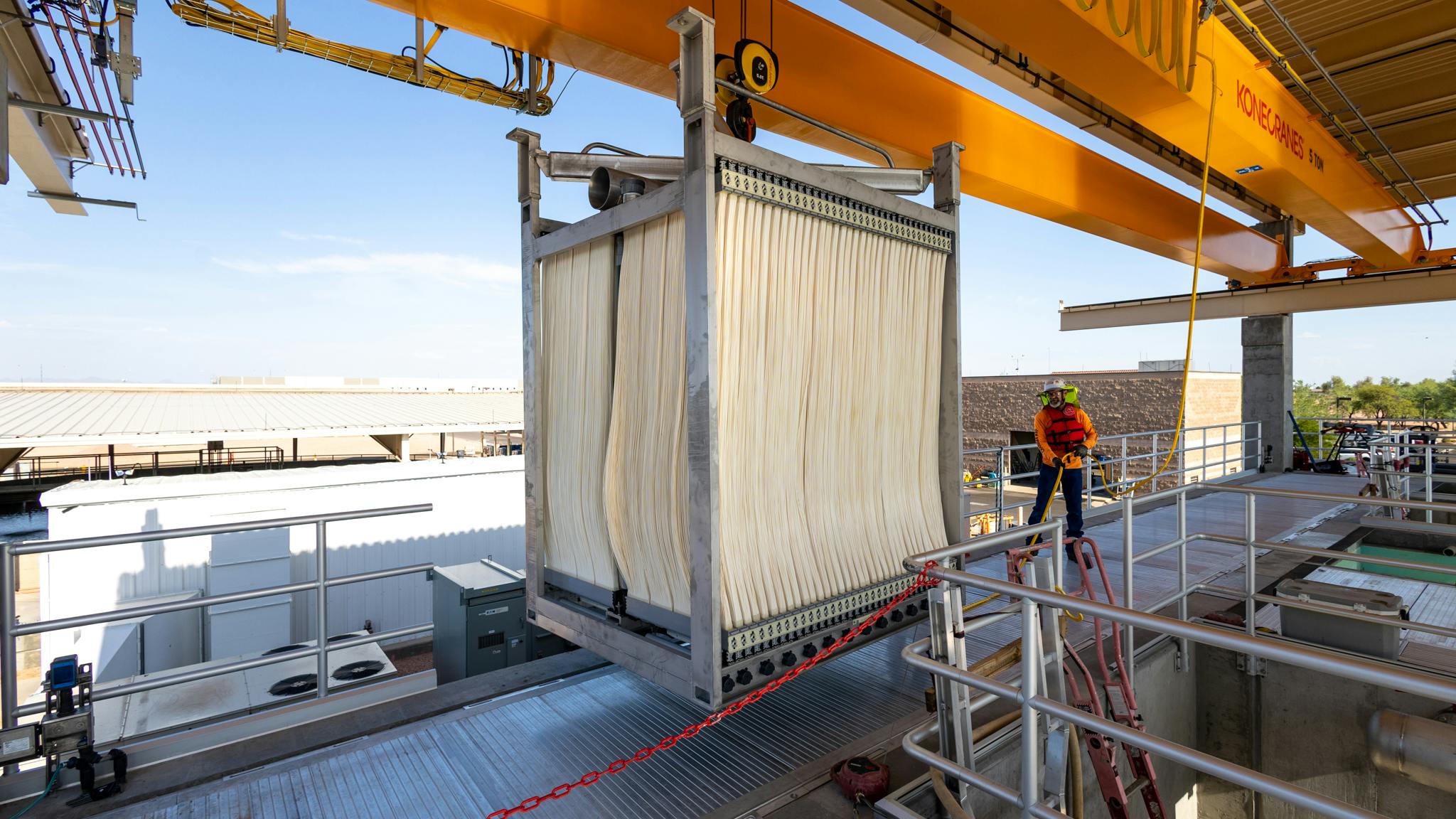 A worker guides a Veolia Zeeweed uiltrafiltration membrane cell into place for installation in Arizona.