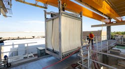 A worker guides a Veolia Zeeweed uiltrafiltration membrane cell into place for installation in Arizona. A worker guides a Veolia Zeeweed uiltrafiltration membrane cell into place for installation in Arizona.
