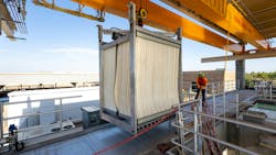 A worker guides a Veolia Zeeweed uiltrafiltration membrane cell into place for installation in Arizona. A worker guides a Veolia Zeeweed uiltrafiltration membrane cell into place for installation in Arizona.