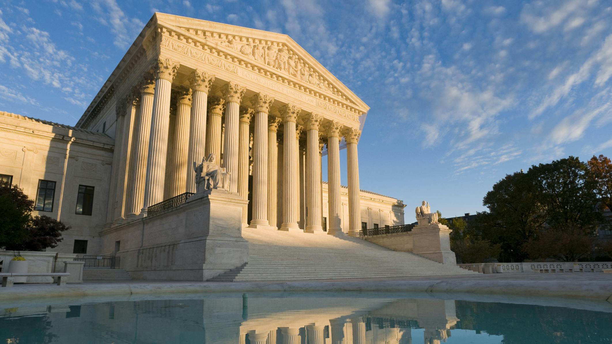 The front of the US Supreme Court in Washington, DC, at dusk.