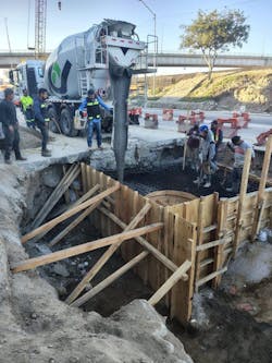 Workers pour concrete around Junction Box #3 Workers pour concrete around Junction Box #3