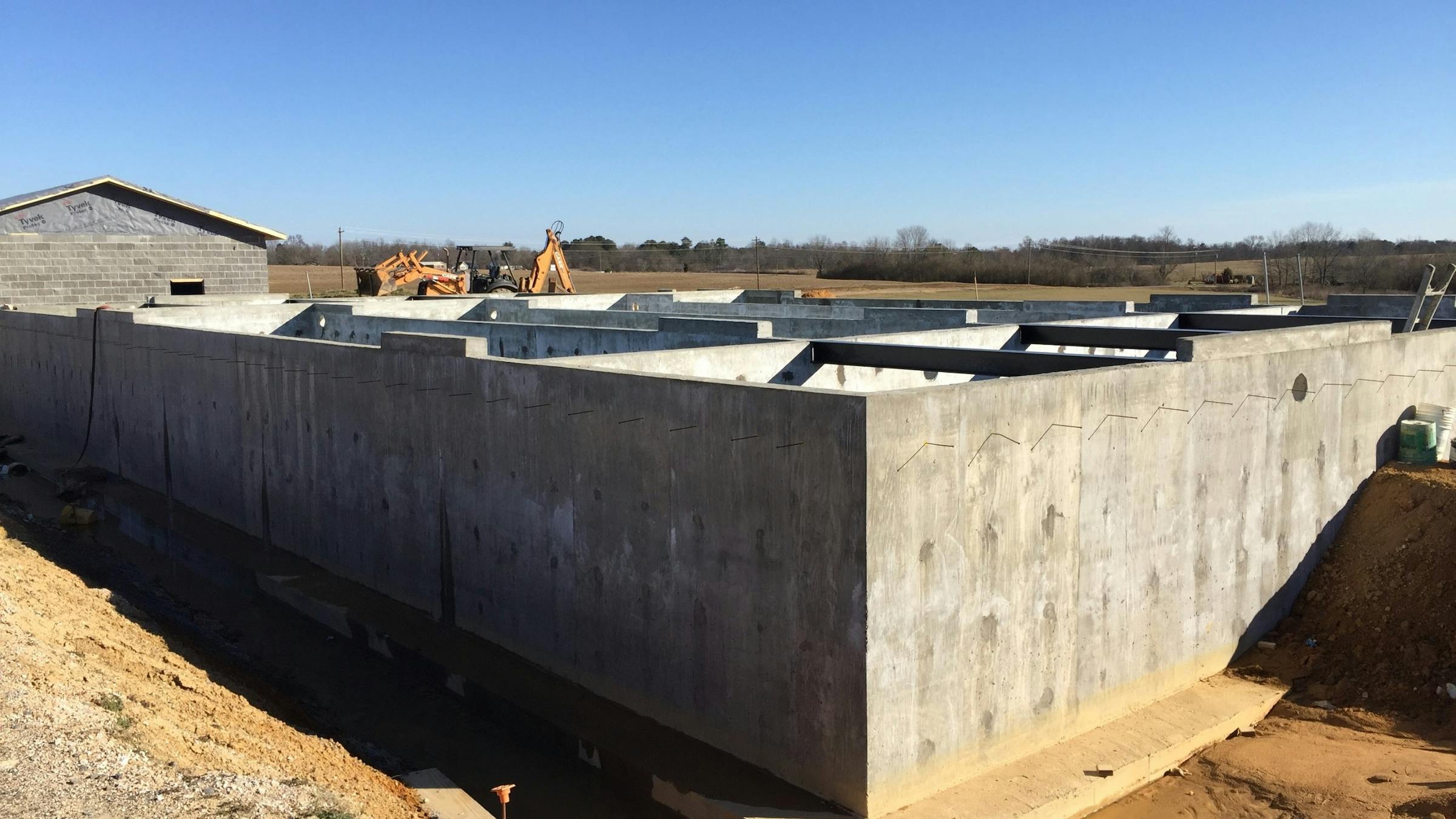 A cast-in-place concrete tank is being constructed by a local contractor to house the ECOPOD treatment unit, and the supporting tank compartments.