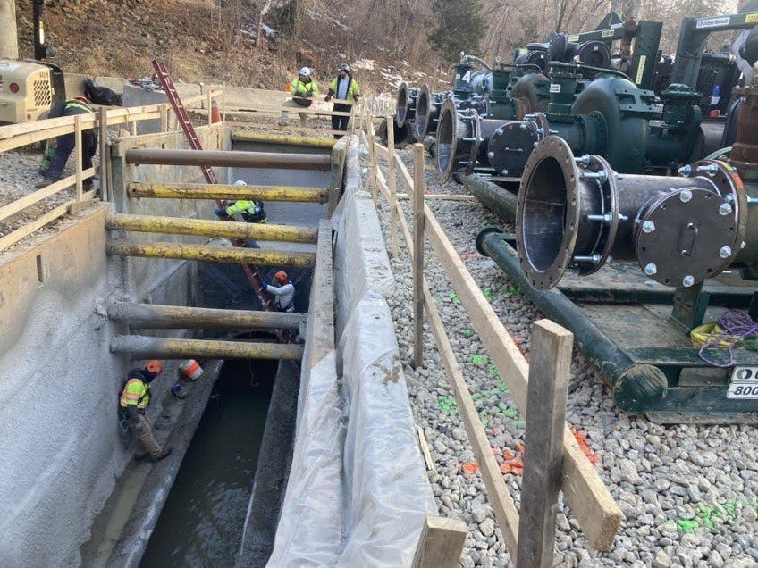 DC Water crews began installation of high capacity bypass pumps February 14. Once fully installed, workers can begin removal of a large rock dam discovered downstream of the original collapse. DC Water crews began installation of high capacity bypass pumps February 14. Once fully installed, workers can begin removal of a large rock dam discovered downstream of the original collapse.