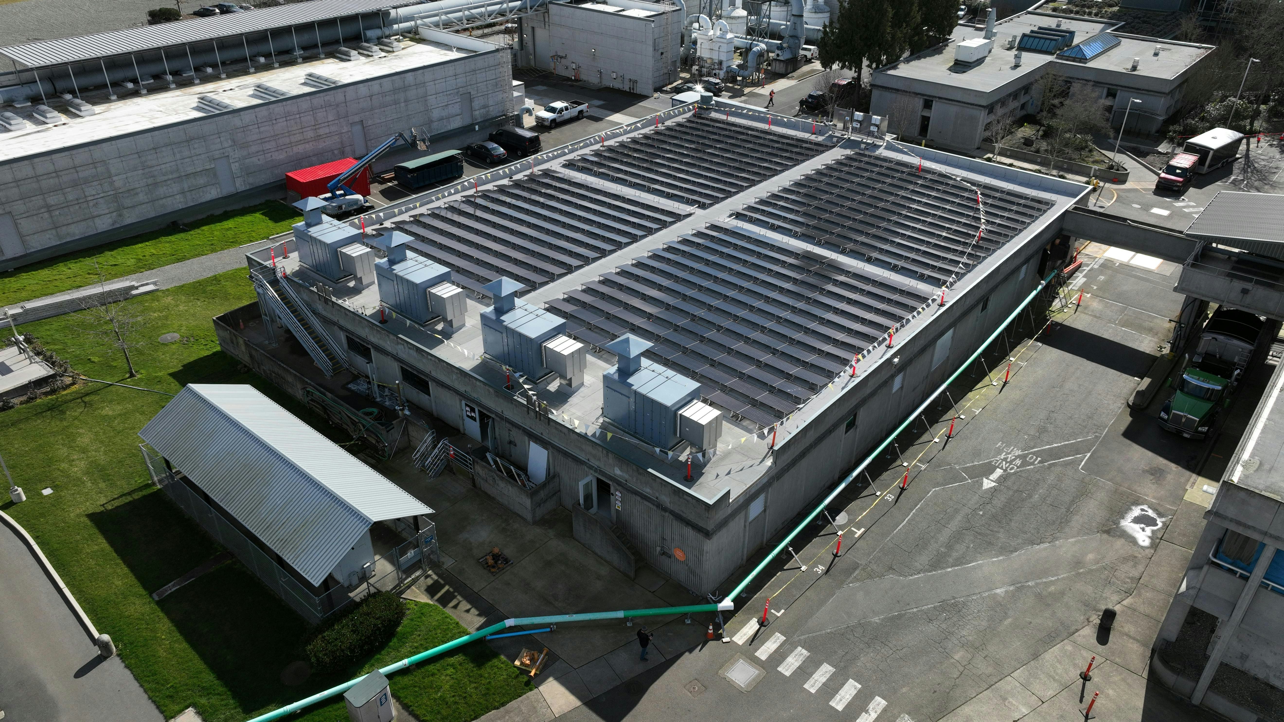 A view of the solar panels and HVAC system upon completion of the Budd Inlet Treatment Plant project that upgraded an aging plant by integrating renewable energy strategies with energy efficient technology that would also achieve compliance targets.