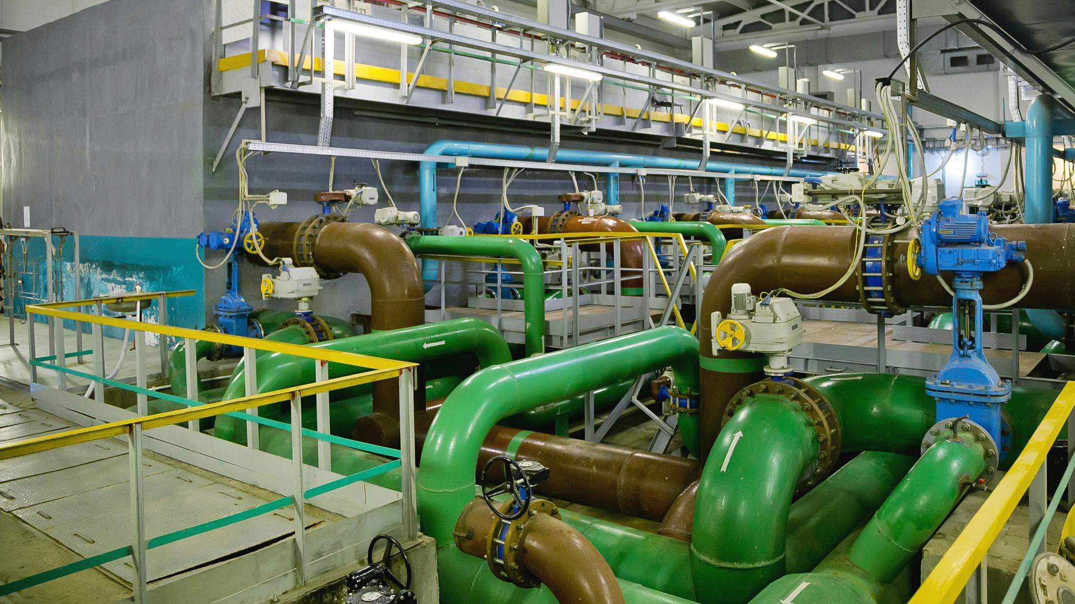 Pipes, filters and sewage pumps inside modern industrial wastewater treatment plant.